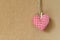 Red textile heart over brown craft recycle cork board background. Valentine`s day concept.