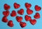 Red textile small hearts on blue background, festive background