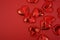 red textile small hearts on red background festive background