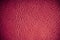 Red textured leather grunge background closeup