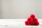 Red textured roses close-up and copy space. Womens day, mother`s day, red roses on a white wooden background