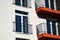 red textured stucco balcony slabs. steel picket railing. perspective view. residential elevation