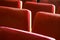 Red theater seats. Empty red velvet seats for spectators in the theater or cinema.