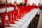 Red-themed wedding table decoration with red napkins and empty glasses