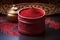 red tilak powder in a carved wooden container
