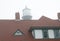 Red Tile Roof with Foggy Lighthouse