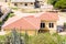 Red Tile Roof on Yellow Plaster Home
