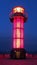 Red tiled lighthouse in Takamatsu at night