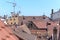 Red tiled rooftops in a town with antennae