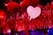 red tinsel with bright hearts on a blue background. concept valentine day and love