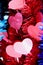 red tinsel with bright hearts on a blue background, selective focus. love concept valentine day