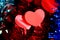 red tinsel with bright hearts on a blue background. valentine day and love