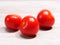 Red tomato on brown wooden background