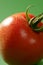 Red tomato macro over green background