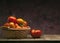 Red tomatoes in basket on dark background