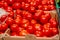 Red tomatoes in boxes. Sale of tomatoes. Delicious ingredient for salads. Healthy Eating