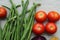 Red tomatoes display with multiple vegetables for health and diet background.