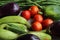 Red tomatoes display with multiple vegetables for health and diet background.