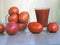 Red tomatoes in a vase and tomato juice