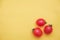 Red tomatos vegetable on a yellow background. Top view. Minimalist Style. Copy, empty space for text