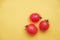 Red tomatos vegetable on a yellow background. Top view. Minimalist Style. Copy, empty space for text
