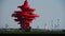 Red torch sculpture & Seaside lighthouse.This public sculpture called May the wind in QingDao City.