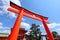 Red torii in front of temple