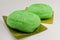 Red Tortoise Cakes or Ang Ku Kueh, a traditional Chinese pastry, seen here with green glutinous rice flour skin