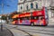 Red touristic sightseeing bus in Porto. Guide bus on Porto streets. Touristic trip concept. Urban transport concept.