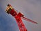 A red tower crane against a blue and grey evening sky.