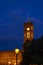 The Red Town Hall in the center of Berlin at night. In the foreground is a historic Berlin lantern on which the focus lies.