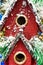 Red toy birdhouse with Christmas theme.