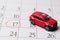 Red toy car is located on the calendar, the number 17 is circled in red