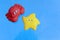 Red toy crab and yellow starfish on blue background