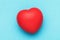 Red toy heart on a blue background