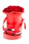 Red toy modern car against luxury red roses in paper hat box on white background