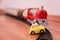 Red toy train and yellow toy car on railroad