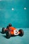 Red toy vintage racing car with number five close up