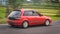 Red Toyota Starlet EP81 driving fast on the road