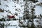 Red tracked snowmobile detail climbing fanes mountain in dolomites on white snow