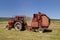 Red tractor and hay baler