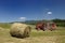 Red tractor and hay baler