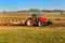 Red tractor pole field. Autumn field work. Life on the farm. Agricultural landscape in the Czech Republic.