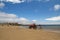 A red tractor towing a boat at Beadnell Bay, Northumberland