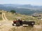 Red tractor with trailer driving along rural outskirts