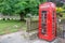 Red traditional english Phone booth in Widecombe in the Moor, Devon UK