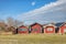 Red, traditional Swedish sommarstuga summerhouses or holiday houses in a sea village. Scandinavian stuga in a row by the ocean