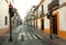 Red traffic lights at morning on empty street of city Cordoba with white wall houses of Andalucia, Spain