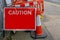 Red traffic sign with information of Caution, on a roadway