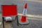 Red traffic sign next to a cone